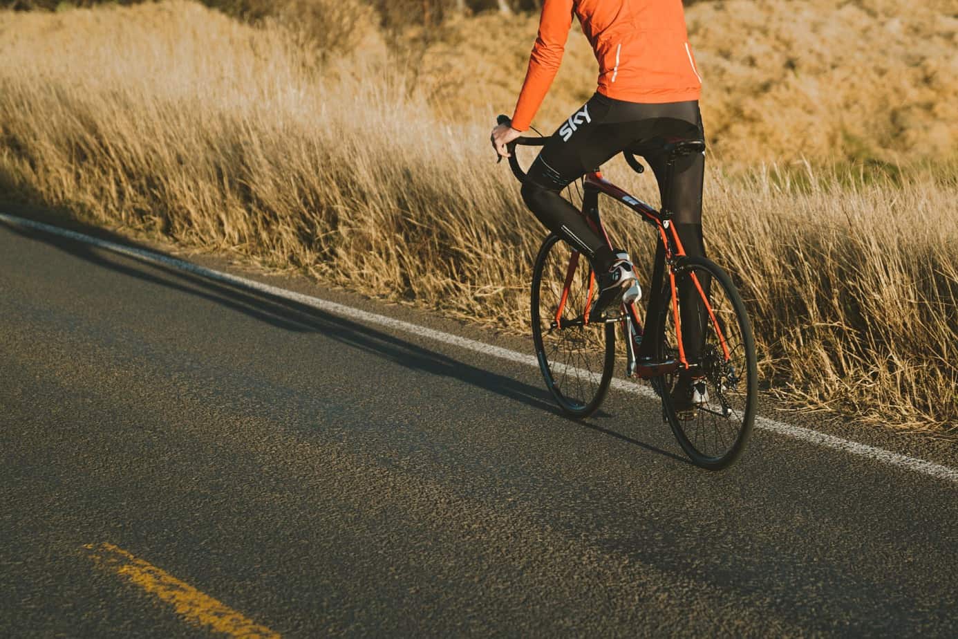 photo of person riding road bike