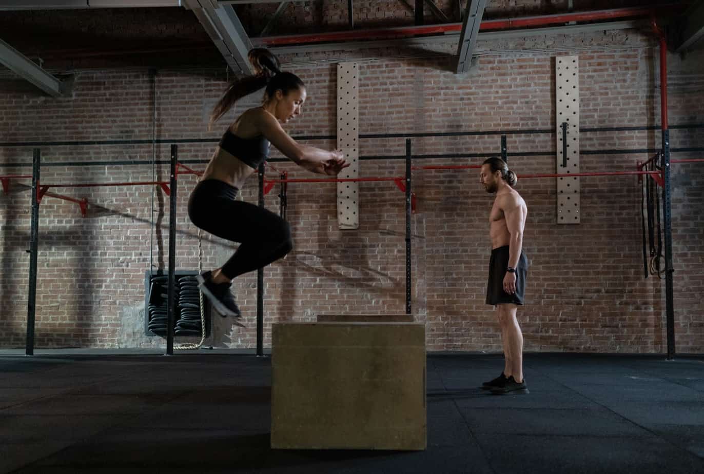 man and woman practicing plyometrics