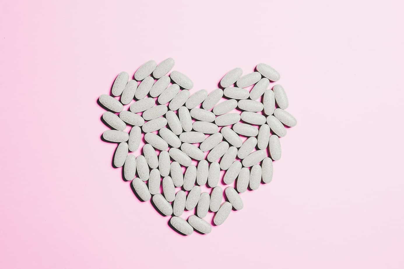 blue medicine pills on heart shape