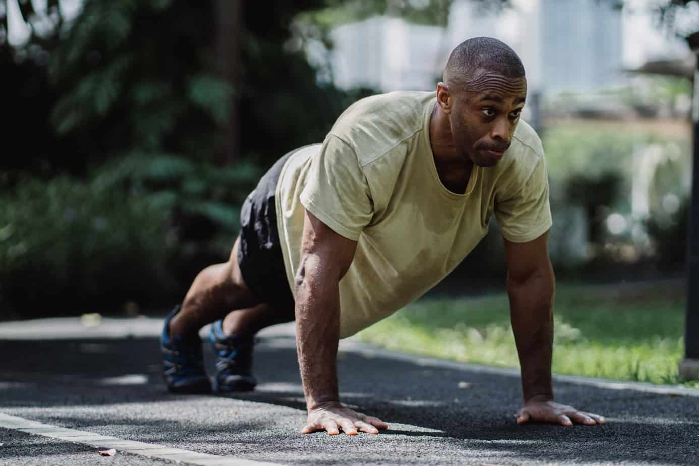 a determined man exercising in the park